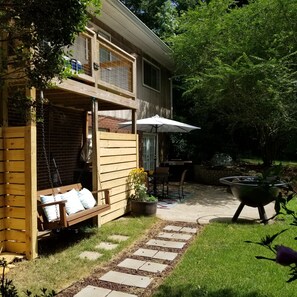 A wooden deck with a swing, a grill, and a patio table with chairs. - Private Basement Apartment (Athens)
