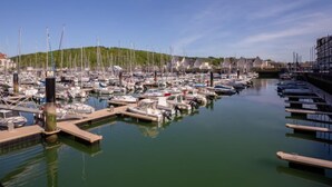 A marina with numerous boats docked, calm water, and a clear sky. - Port Guillaume by Interhome (Cabourg)