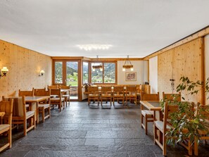 Enjoy meals in this dining area with a high ceiling and mountain views.