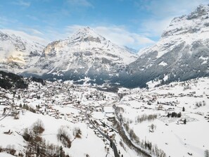 A snow-covered mountain town with a valley, buildings, and roads.