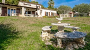 A white villa with a stone fountain, surrounded by a well-maintained lawn and a wooden fence. - La Mesnière by Interhome (Vence)