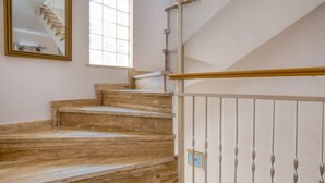 A staircase with wooden steps and a white railing.