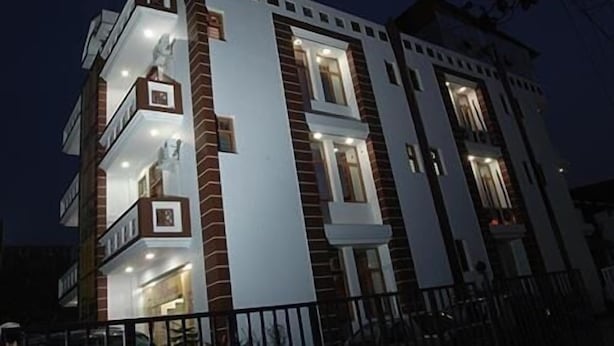 A multi-story building with balconies and large windows. - Hotel Galaxy (Dehradun)