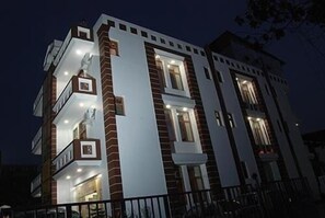 A multi-story building with balconies and large windows. - Hotel Galaxy (Dehradun)