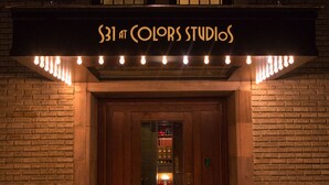 A building entrance with a sign reading "531 at Colors Studios" and a set of lights above the door. - School 31 Lofts at Colors Studios (Rochester)