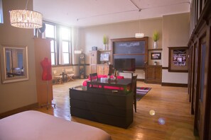 Luxury:LOFTS | Living area | 60-inch Smart TV with cable channels, TV, first-run movies - School 31 Lofts at Colors Studios (Rochester)