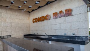 A kitchen area with a countertop and a sink. The wall has a sign that reads "CONDO BAR". - San Pedro Hotel 5ta Avenida (Playa del Carmen)