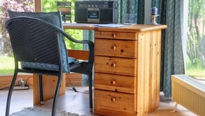 A wooden desk with a radio, a chair, and a radiator. - Solling by Interhome (Uslar)