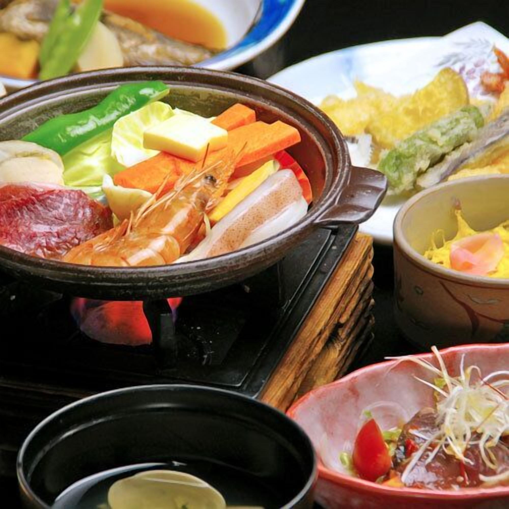 A variety of dishes, including seafood and vegetables, served on a table.