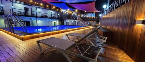 Seasonal outdoor pool, open 9:00 AM to 9:00 PM, pool umbrellas