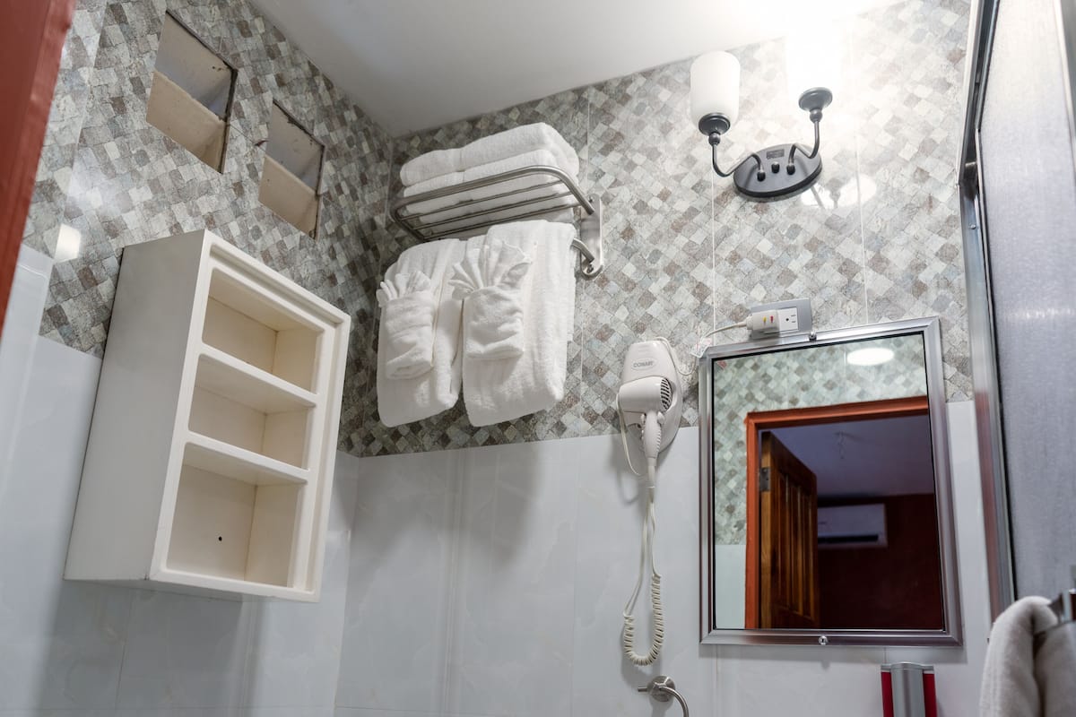 deluxe triple room | bathroom | shower, rainfall showerhead, slippers, towels