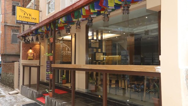 A hotel exterior with a sign for 'FYK Flying Yak Kathmandu'. - Flying Yak Hotel - Hostel (Kathmandu)