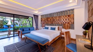 A modern hotel room with a large bed, a sofa, a desk, and a view of a swimming pool. - Araya Angkor Residence (Siem Reap)
