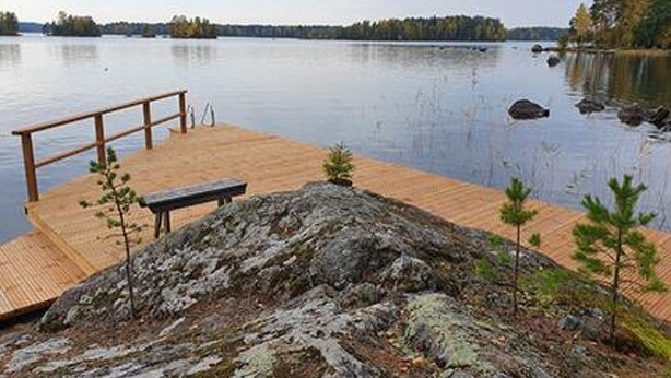 A wooden dock extending into a calm lake with a distant forest view. - Vacation home Rihka by Interhome (Hämeenlinna)