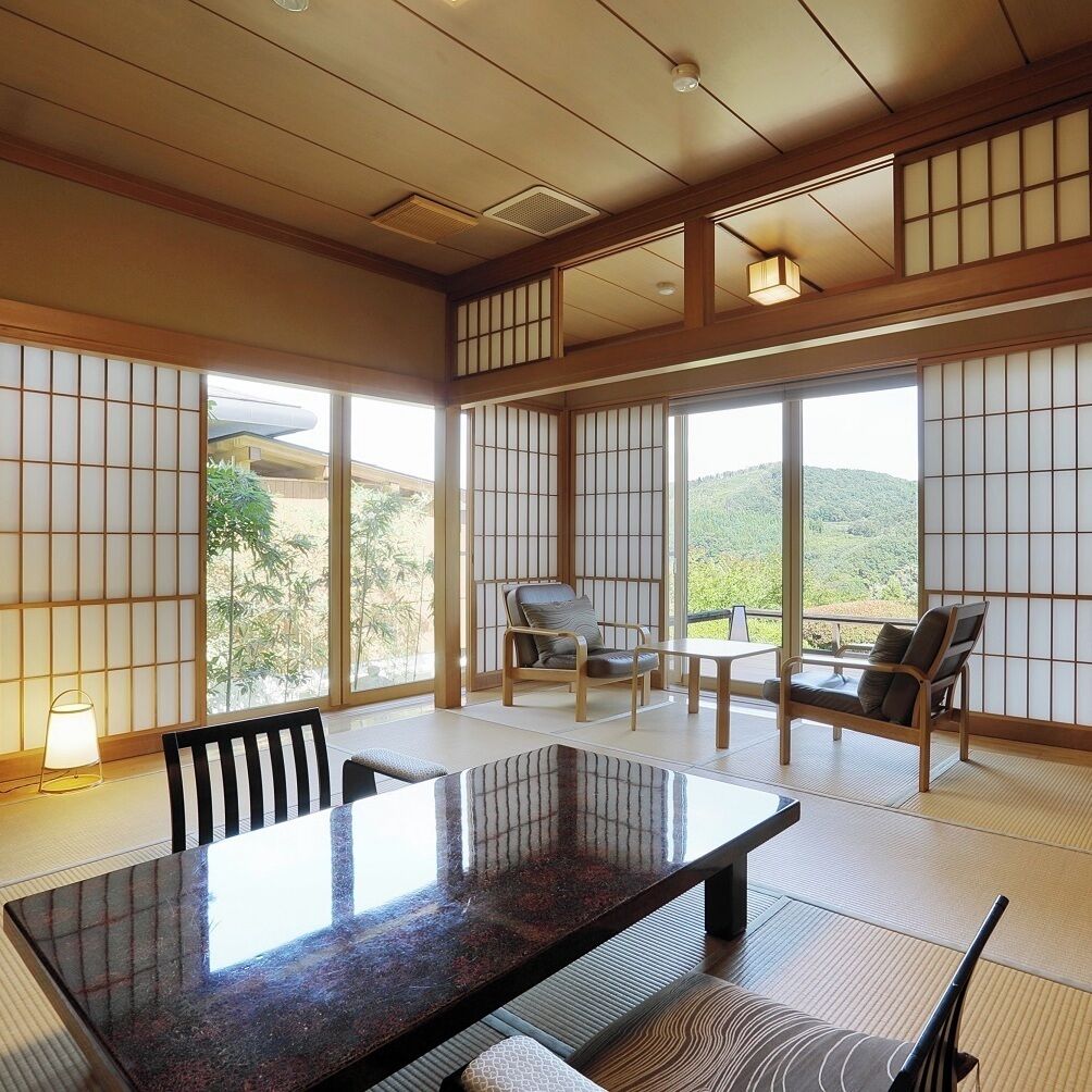 A traditional Japanese-style room with tatami flooring, a low table, and sliding doors.