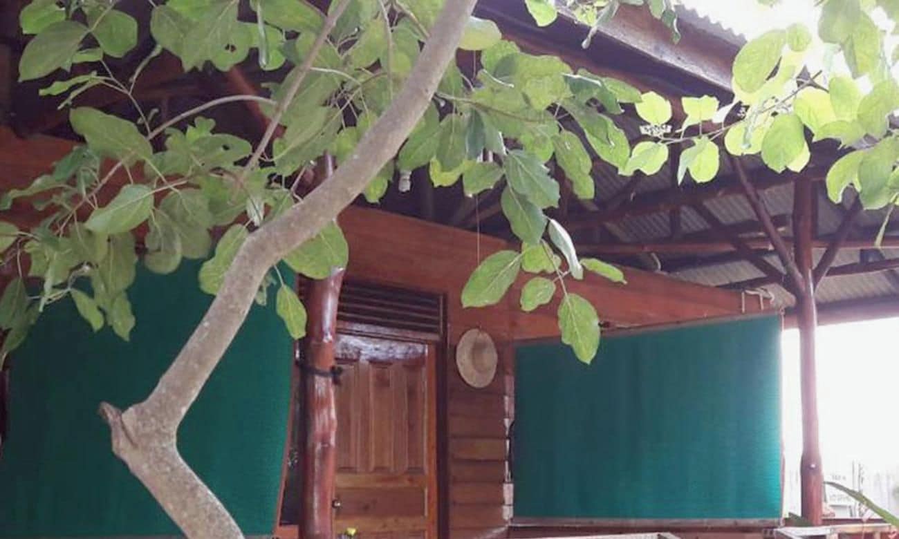 A wooden building with a door and a covered porch area.