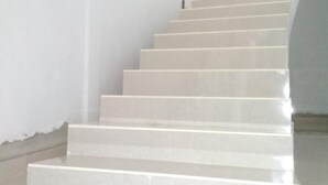 A staircase with a modern design, leading to an upper floor. - Almira Homestay (Jambi)