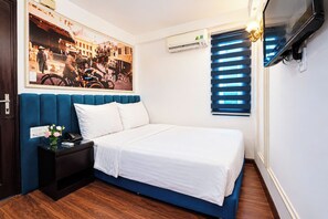 A hotel room with a bed, a nightstand, a wall-mounted air conditioner, a window with blinds, and a framed picture on the wall. - Hanoi Endless Hotel (Hanoi)