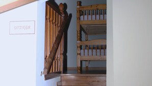 A wooden staircase with a wooden handrail and a sign on the wall.