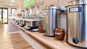 A buffet setup with multiple stainless steel dispensers and ceramic pots, likely for food or beverages. - Ichihara Inn Social Goi (Ichihara)