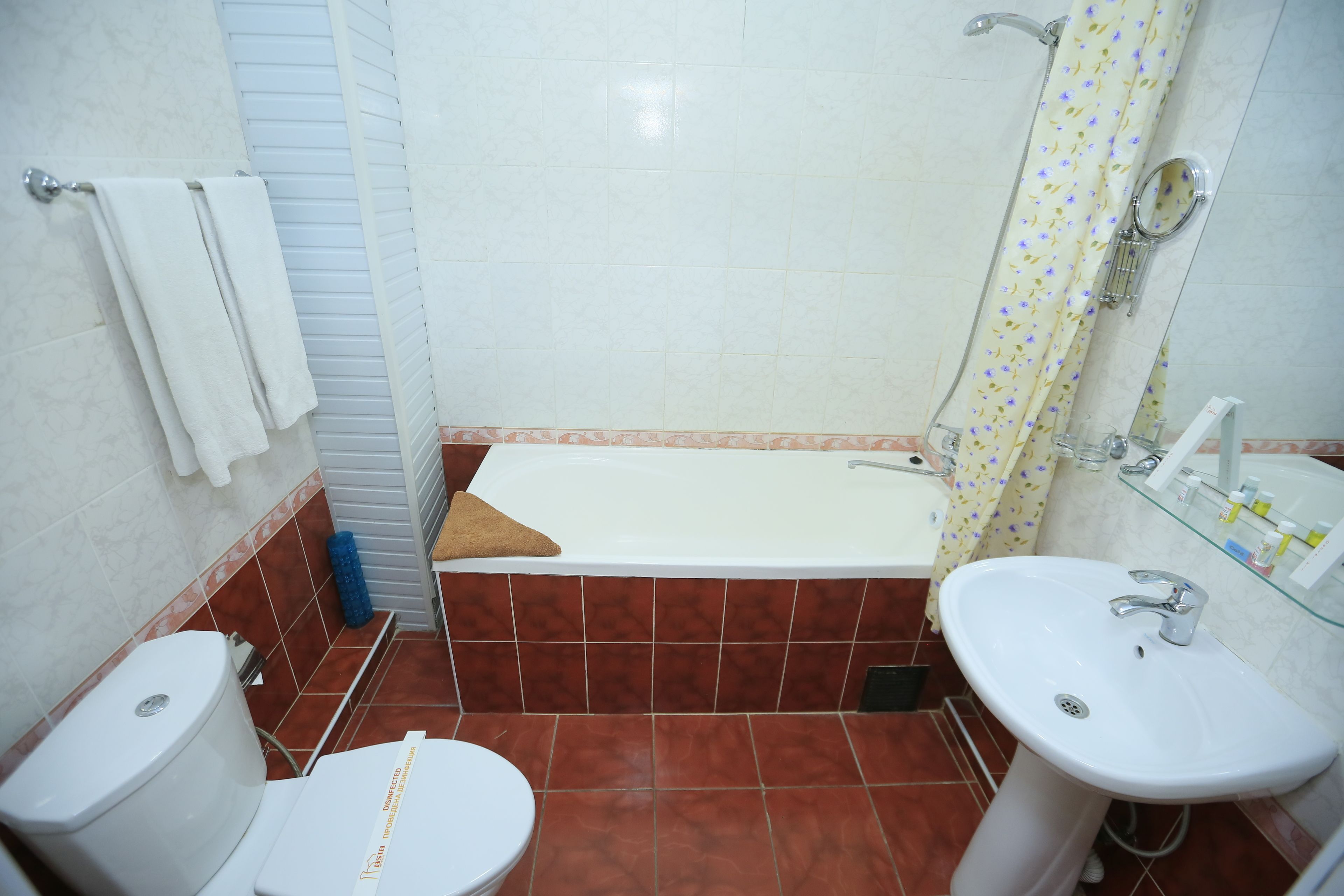 A bathroom with a bathtub, toilet, and sink.