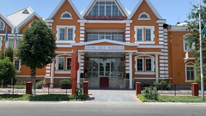 A hotel with a symmetrical facade, large windows, and a central entrance. - Asia Hotel Fergana (Fergana)