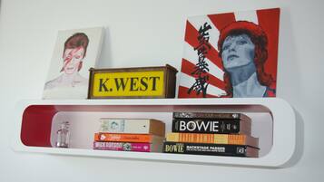A bookshelf with books and a framed picture.