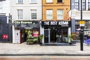 A storefront with a sign for "City Express" and "The Best Kebab".