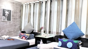 A hotel room with two beds, a small table with amenities, a mirror, and a curtain. - W's Lounge (Kowloon)