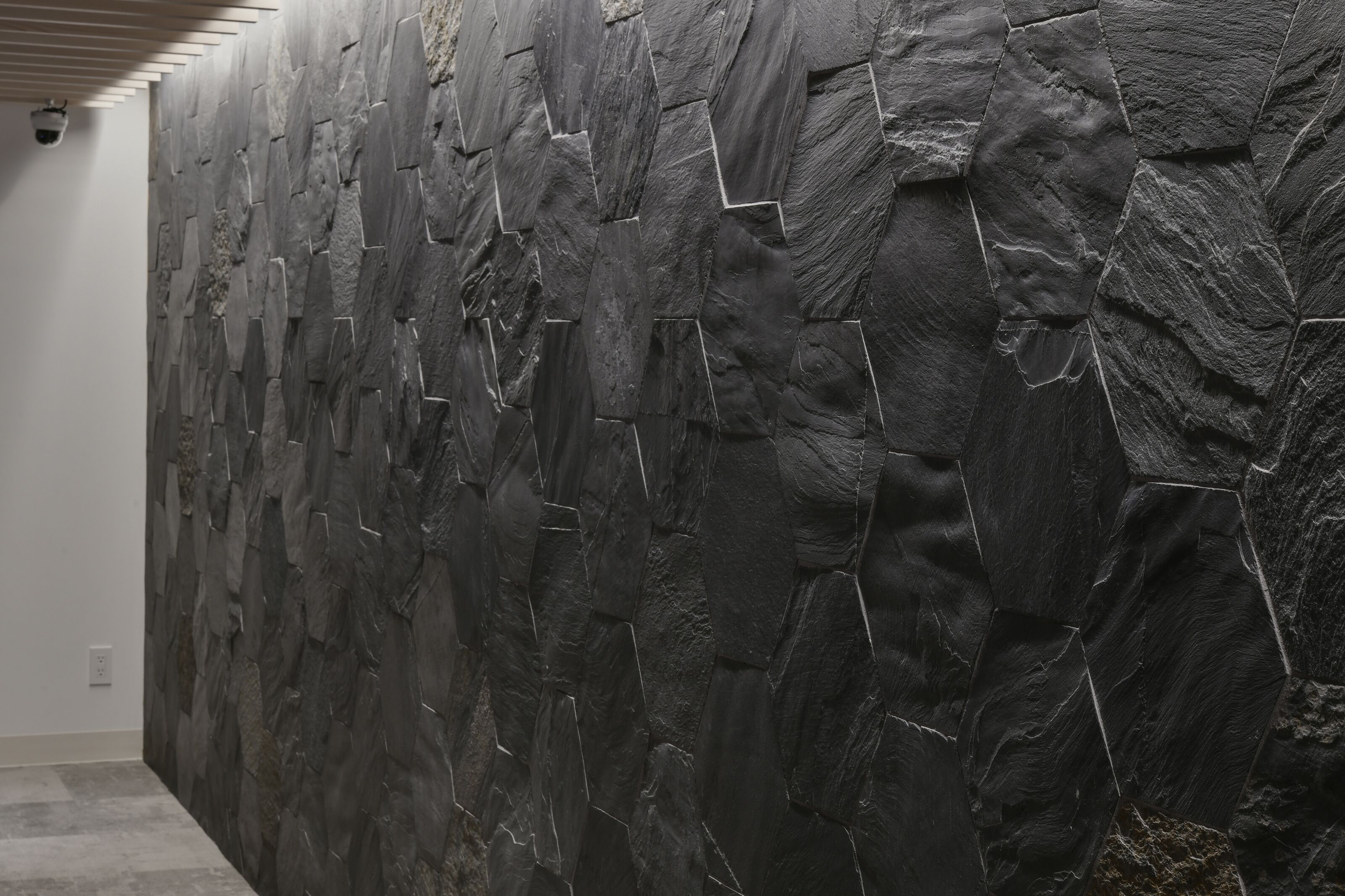 A wall with a textured, stone-like pattern.