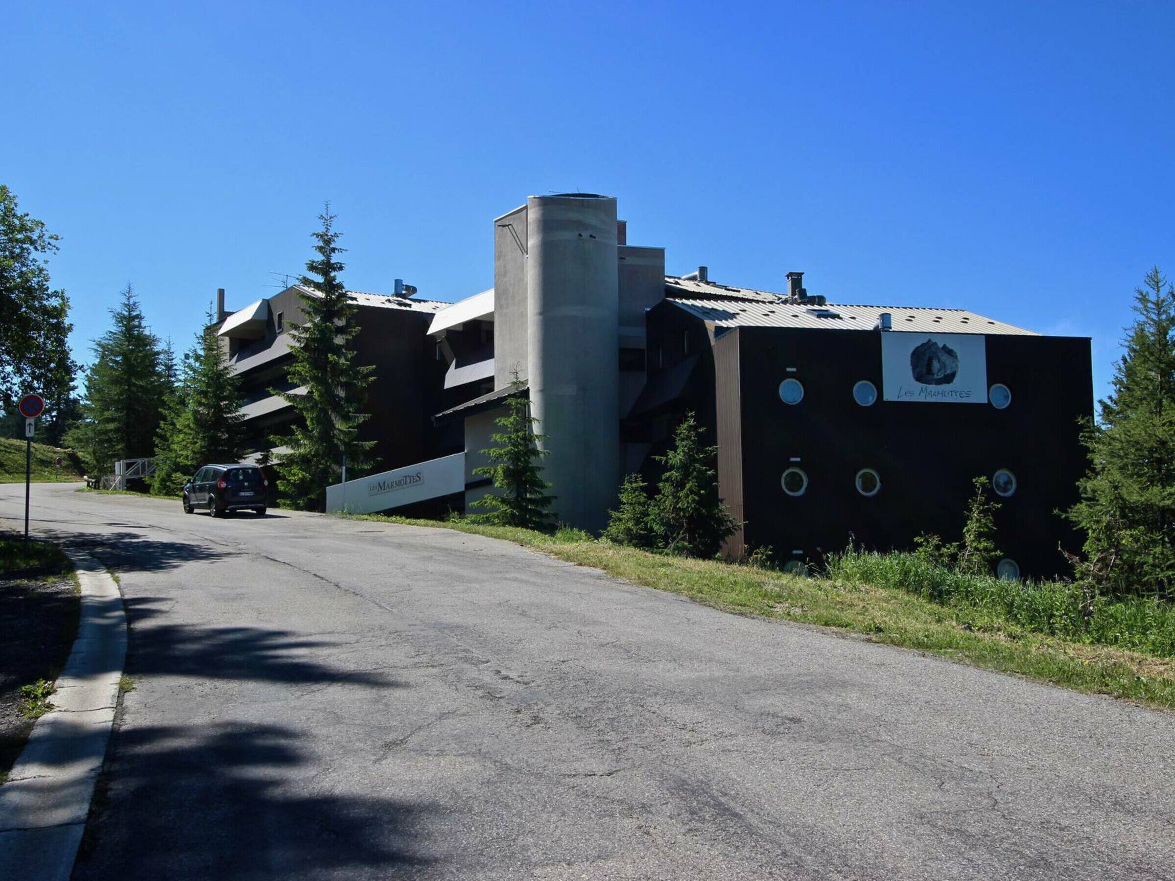 A modern building with a sign reading "Les Marmottes."