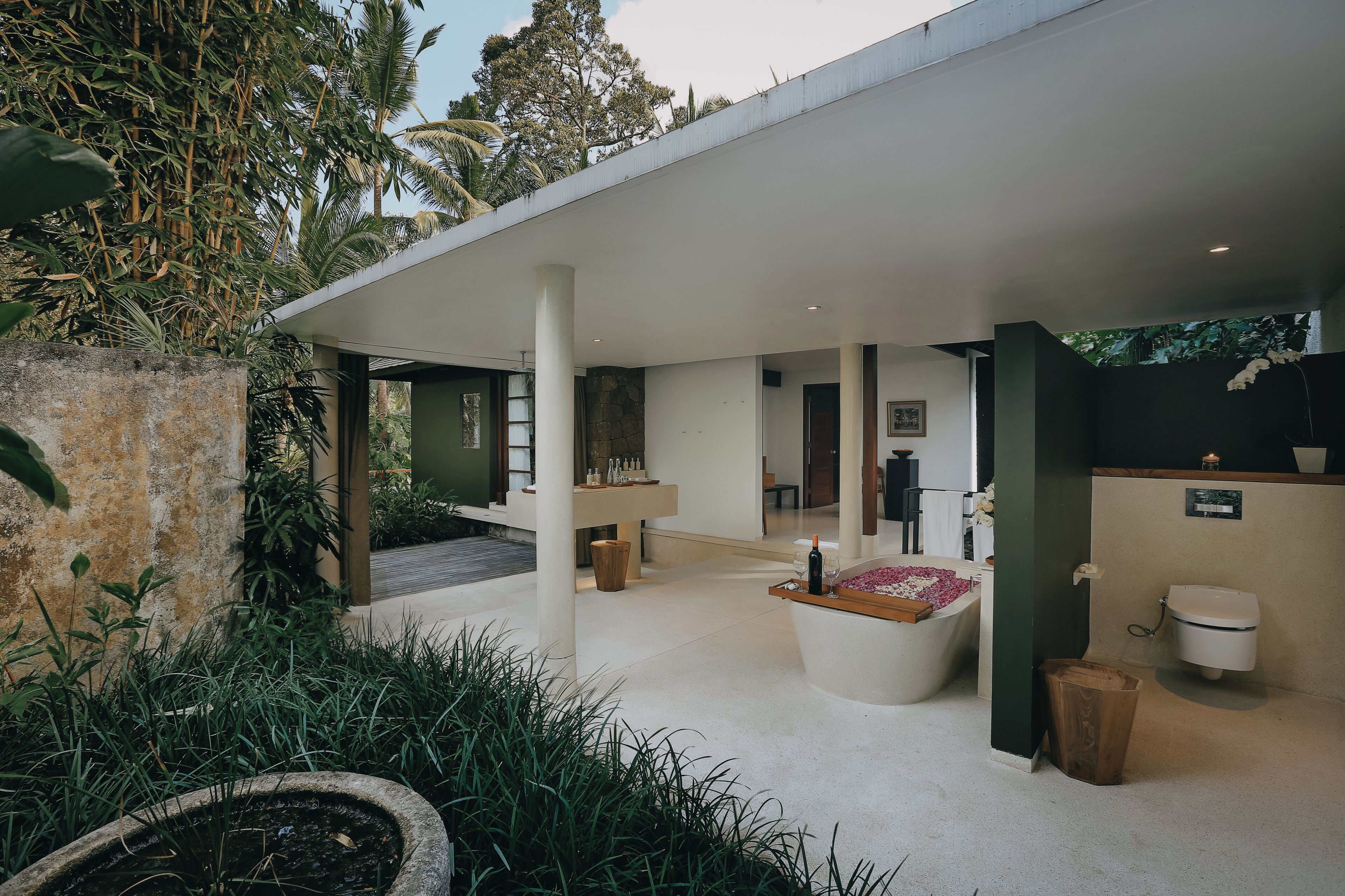 A modern bathroom with a bathtub, toilet, and sink.