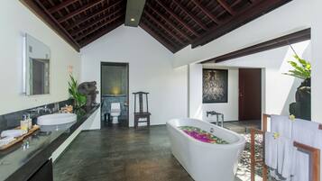 A modern bathroom with a freestanding bathtub, a large mirror, and a wooden ceiling.