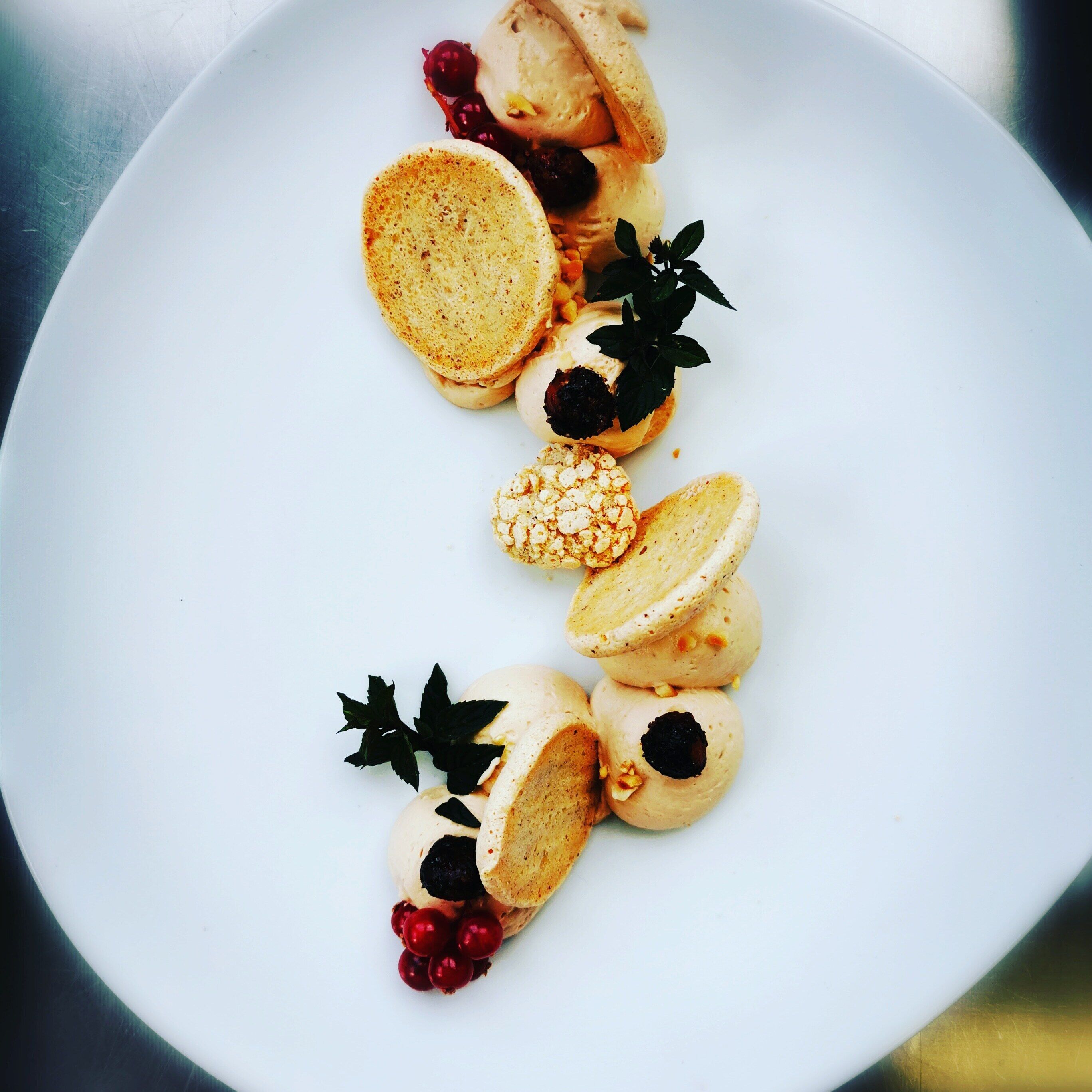 A white plate with a variety of pastries and berries.