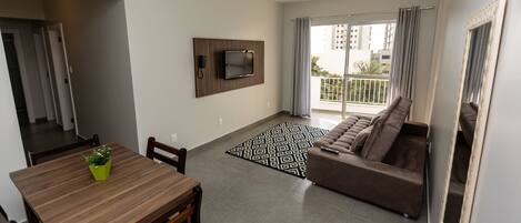 Deluxe Apartment | Living area | 32-inch flat-screen TV with cable channels, TV