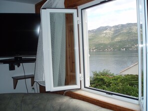 Apartment, 2 Bedrooms, Balcony, Sea View | Living area | Flat-screen TV