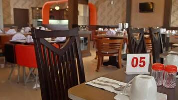 A restaurant interior with wooden chairs, tables, and a number sign indicating table 05.