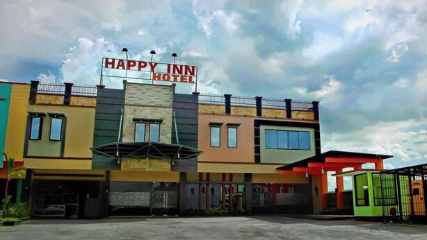 A multi-story building with a sign reading "HAPPY INN HOTEL".