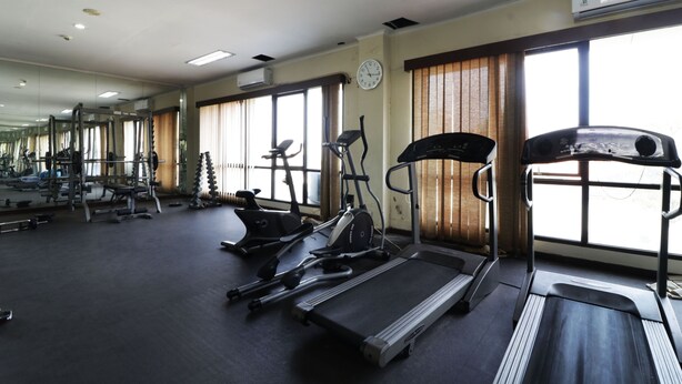 A gym with treadmills, elliptical machines, and weight equipment. - Wisma Konservasi (Jakarta)