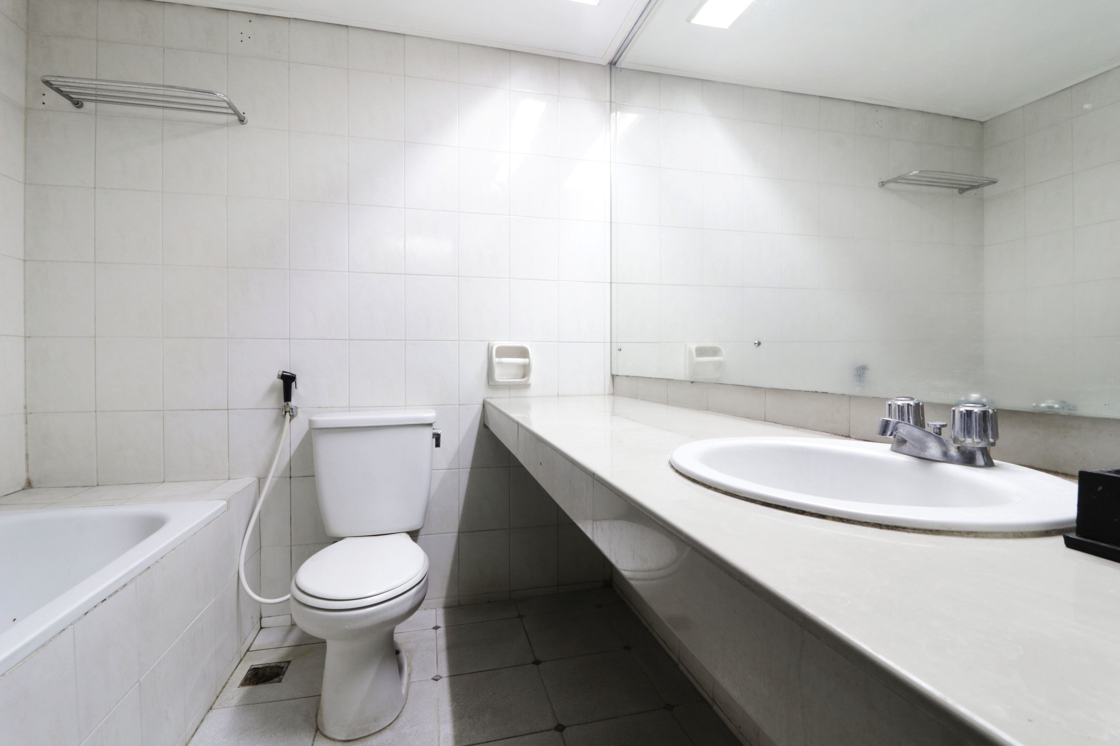 A modern bathroom with a toilet, sink, and bathtub.