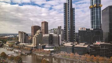 A cityscape with modern high-rise buildings, a river, and a bridge.