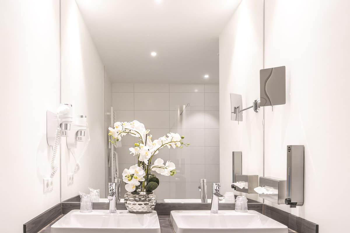 junior suite, multiple beds (living room;with sofabed) | bathroom | shower, towels