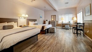 A hotel room with two beds, a desk, and a chair. - Hamilton Village Inn (North Kingstown)