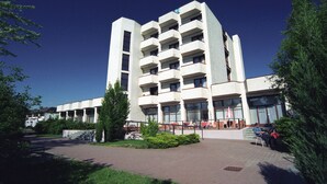 A multi-story building with a central courtyard, featuring a mix of balconies and windows. - Ensana Spa Smrdaky (Smrdáky)
