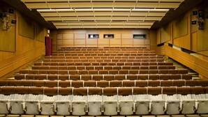 A large auditorium with tiered seating, a stage at the front, and a red curtain. - Ensana Spa Smrdaky (Smrdáky)