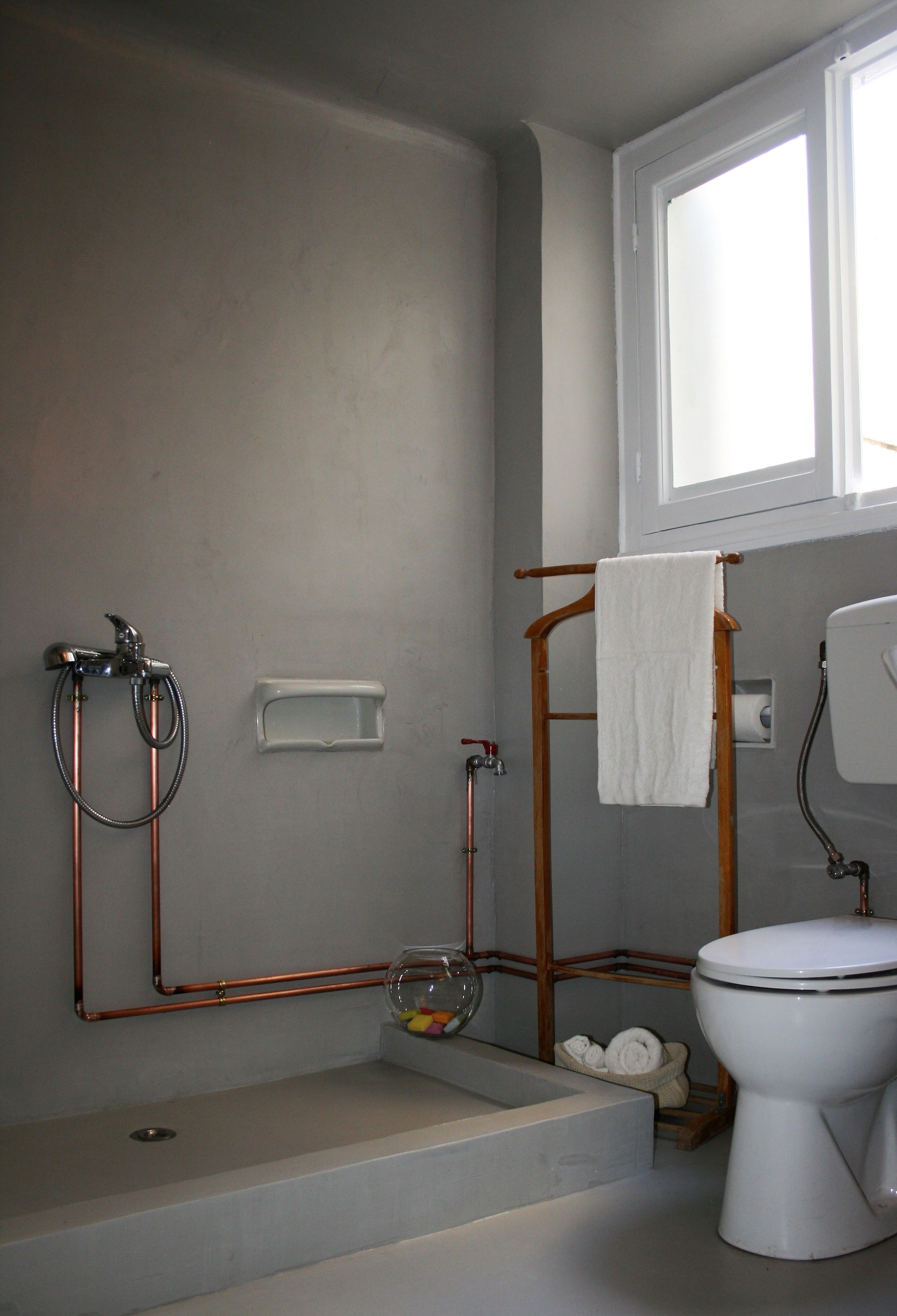 A bathroom with a shower, toilet, and sink.