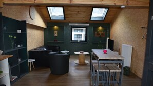 A compact kitchen with a dining area, skylights, and a small window. - Le Toit de Dinant - Esc’Appart (Dinant)