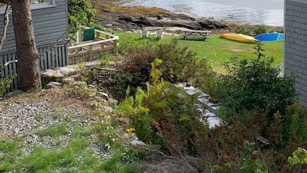 A coastal property with a view of the sea, boats, and a small island in the distance. - New Listing - Island View Cottage (Phippsburg)