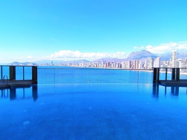 An infinity pool with a cityscape view.