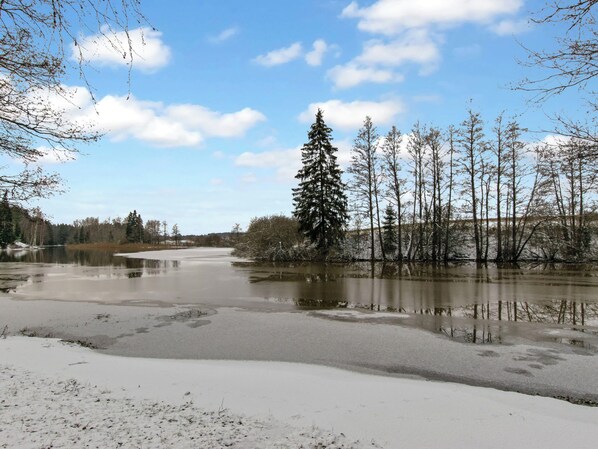 A frozen river with trees and a clear sky.